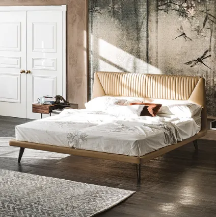 Bed with shaped padded headboard covered in Amadeus leather by Cattelan Italia