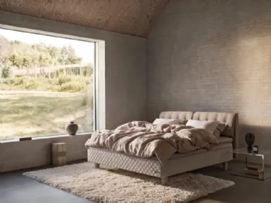 Bed with quilted fabric headboard by Duxiana