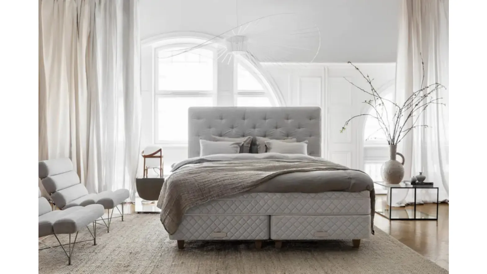 Bed with a Royal upholstered and quilted headboard by Duxiana