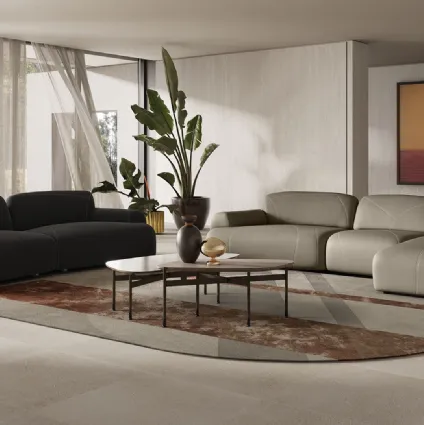 Leather sofa with peninsula or linear in fabric Buddie by Natuzzi.